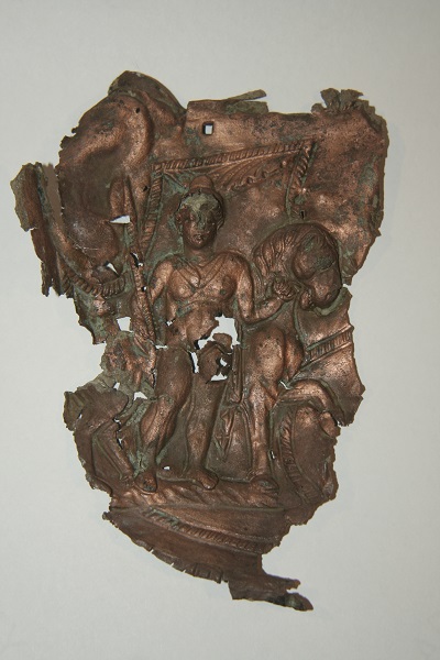 Roman Cavalry Cheek Piece depicting a figure holding a spear in one hand and the reins of his horse in the other
